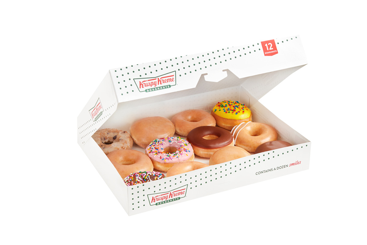 amazon e-commerce photography of an assorted dozens box of Krispy Kreme doughnuts partially opened shot on white.