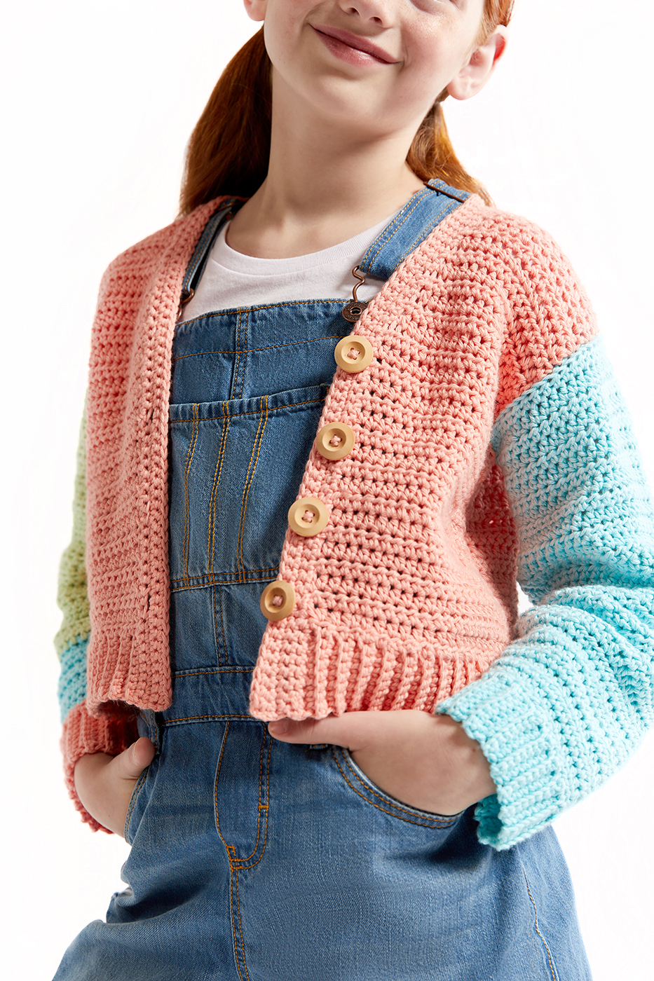 e-commerce fashion photography of young girl with red hair wearing a crocheted color blocked sweater.