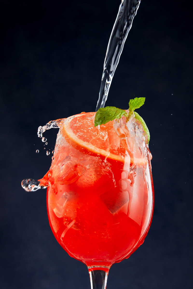 Commercial food photography of Prosecco cocktail pouring into wine glass styled by food photographer