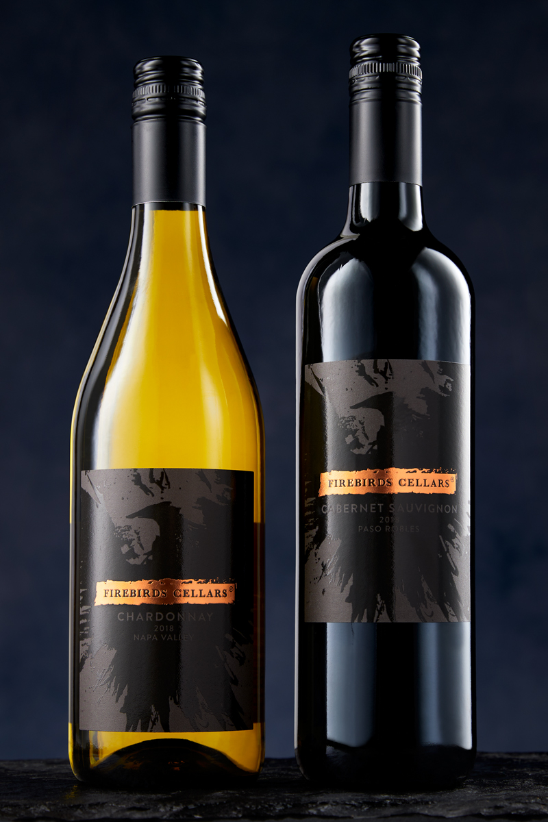 Commercial wine photography in studio of Firebirds Wood Fired Grill Chardonnay and Cabernet on black background