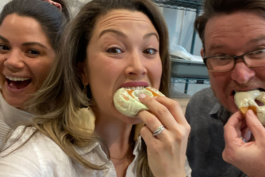 Candid photo of Salt Paper Studio team members eating doughnuts together
