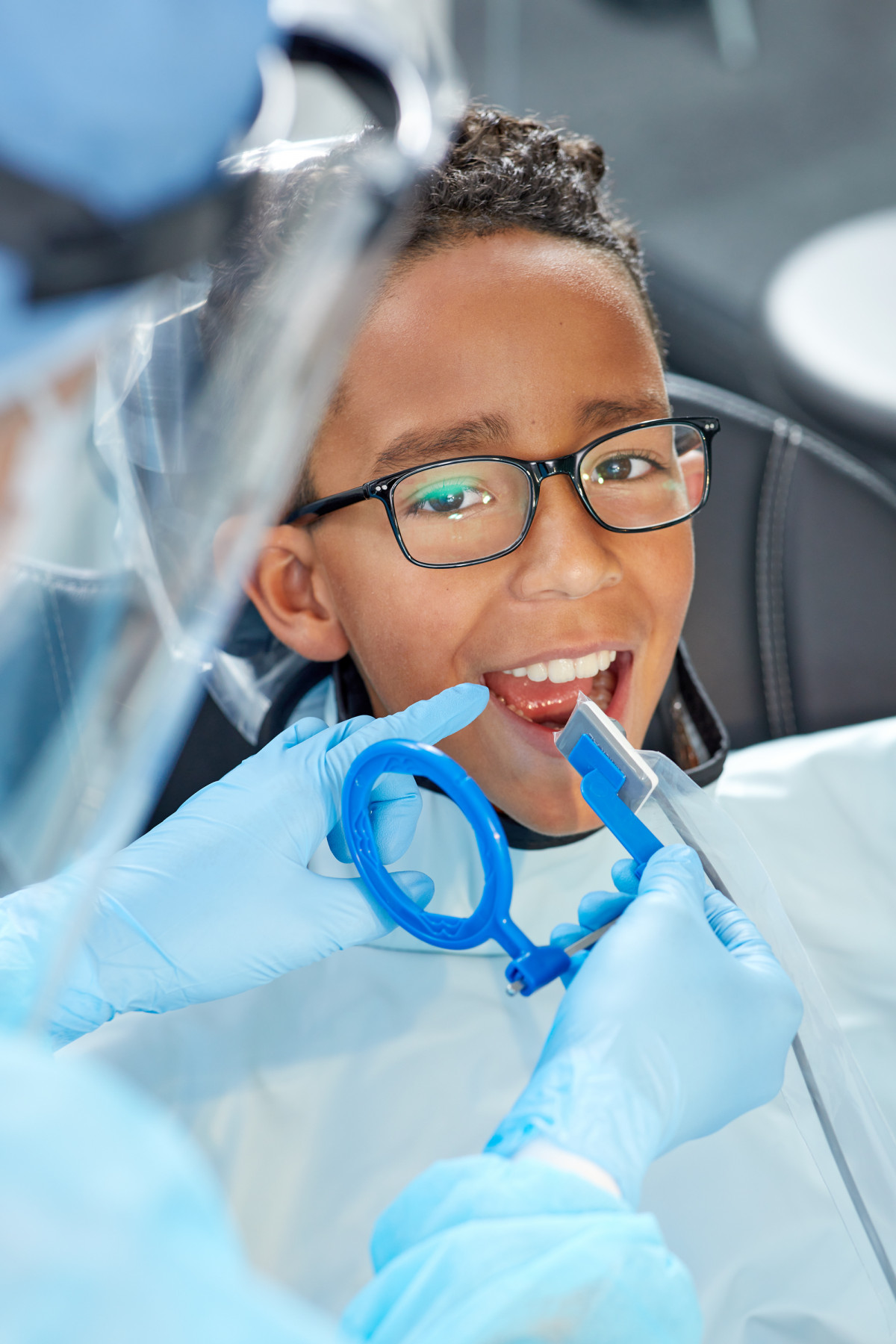 Young boy in dentist chair being prepped for x-rays