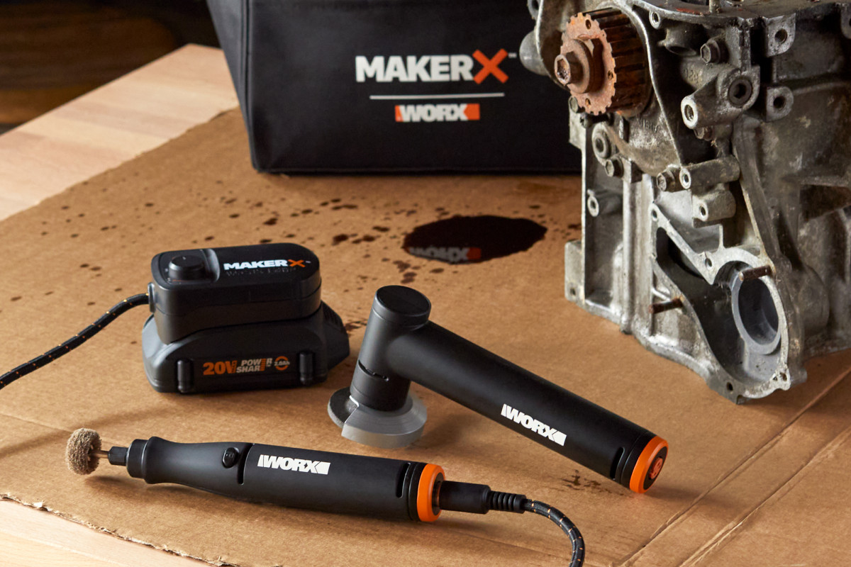 Product photography of various WORX tools on a workbench next to an engine