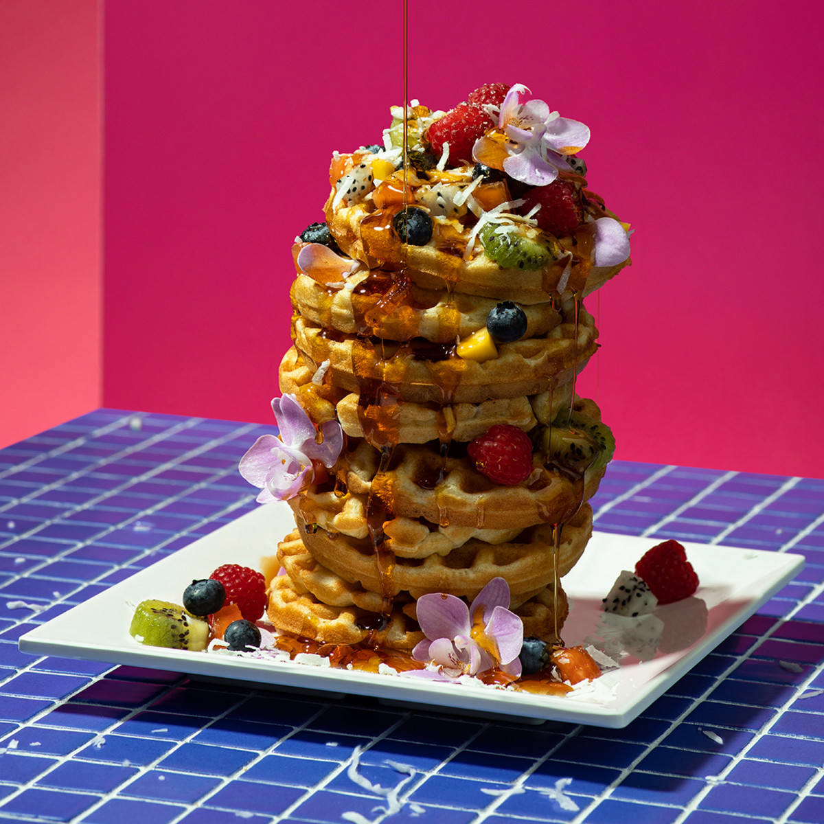 commercial food photograph of waffle stack created for Adobe all apps with pink and purple background