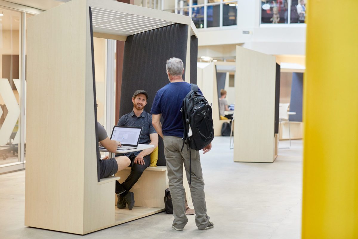 Interior photography of a modern workspace with two colleagues conversing